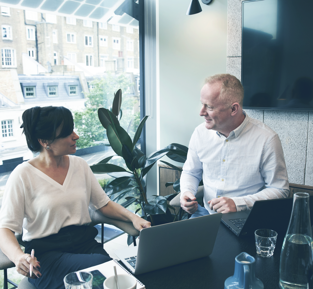 man and woman talking at table